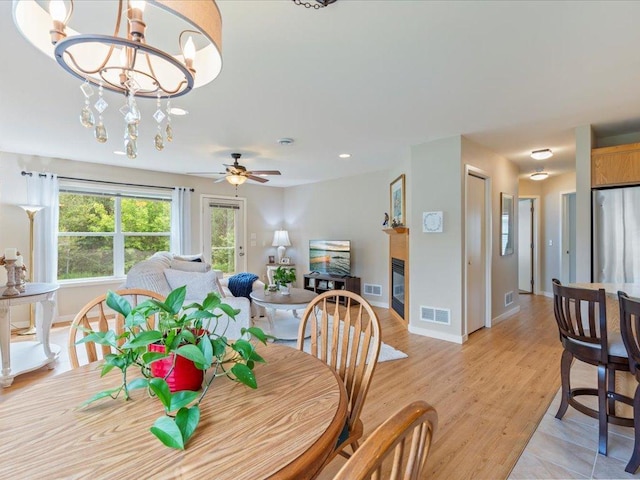 8025 Dalton Rd, Baxter, MN 56425 - dining space featuring baseboards, a glass covered fireplace, light wood-style flooring, ceiling fan, and recessed lighting