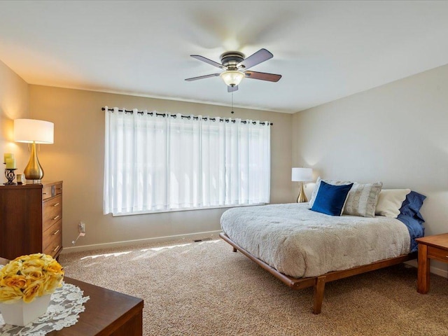 8025 Dalton Rd, Baxter, MN 56425 - carpeted bedroom with multiple windows, baseboards, and ceiling fan