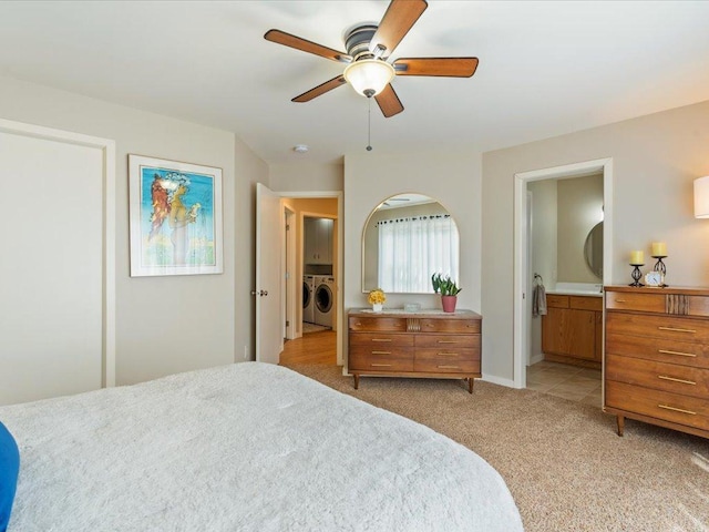 8025 Dalton Rd, Baxter, MN 56425 - bedroom featuring washing machine and clothes dryer, light colored carpet, connected bathroom, and ceiling fan