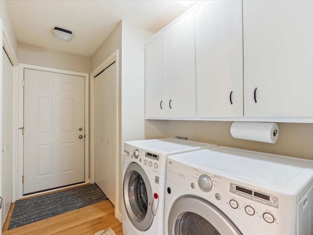 8025 Dalton Rd, Baxter, MN 56425 - washroom featuring cabinet space, washing machine and clothes dryer, and light wood finished floors