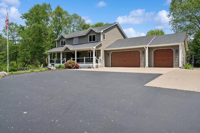 17575 Xenia St NW, Andover, MN 55304 - view of front facade with covered porch, a garage, asphalt driveway, and roof with shingles