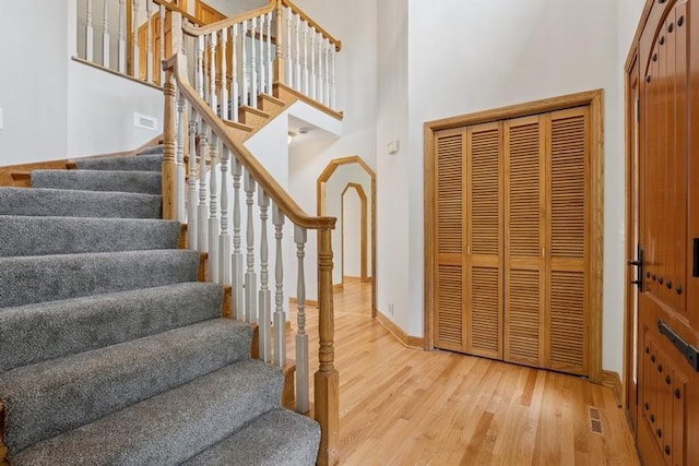 17575 Xenia St NW, Andover, MN 55304 - stairs with wood finished floors, a high ceiling, and baseboards
