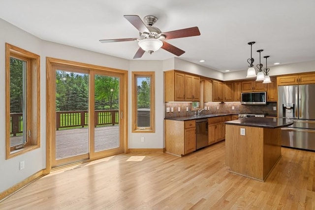 17575 Xenia St NW, Andover, MN 55304 - kitchen with appliances with stainless steel finishes, a sink, tasteful backsplash, dark countertops, and baseboards