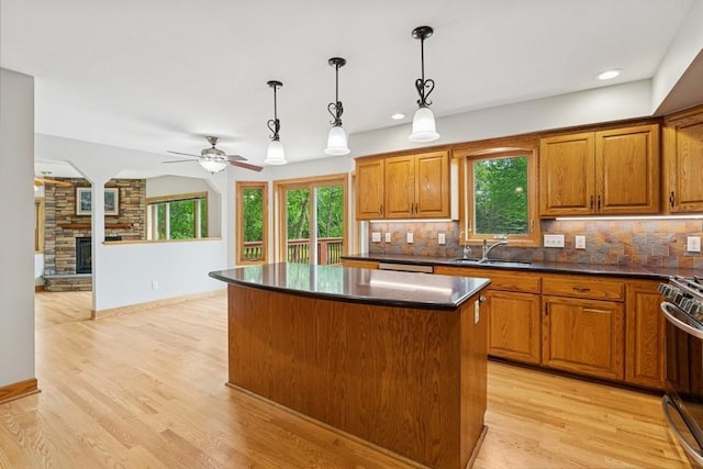 17575 Xenia St NW, Andover, MN 55304 - kitchen featuring a sink, dark countertops, a ceiling fan, brown cabinets, and recessed lighting