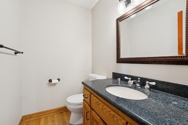 17575 Xenia St NW, Andover, MN 55304 - half bathroom featuring toilet, vanity, and wood finished floors