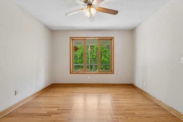 17575 Xenia St NW, Andover, MN 55304 - spare room featuring light wood finished floors, a ceiling fan, and baseboards