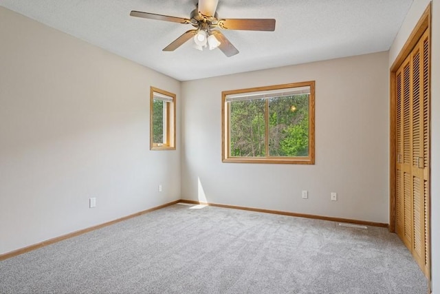 17575 Xenia St NW, Andover, MN 55304 - unfurnished bedroom featuring a closet, carpet, baseboards, and ceiling fan