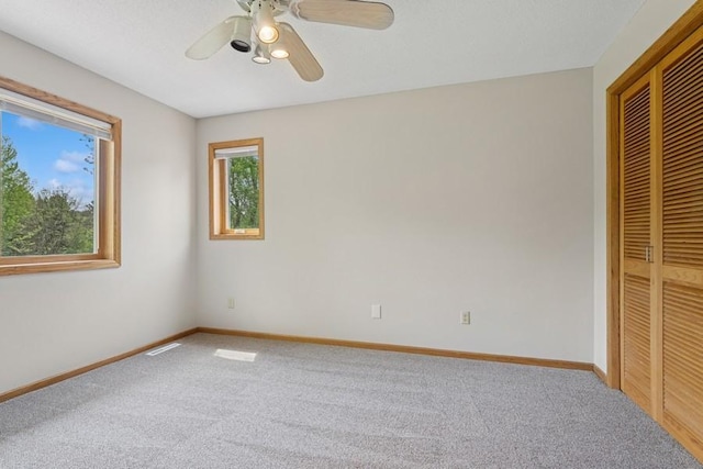 17575 Xenia St NW, Andover, MN 55304 - unfurnished bedroom featuring carpet flooring, a closet, baseboards, and ceiling fan