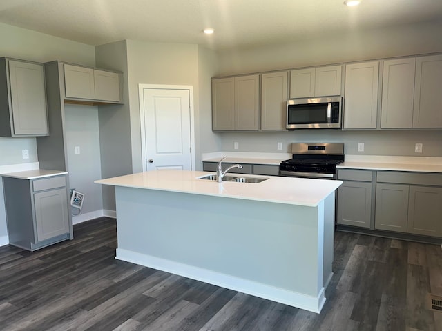 6573 209th St W, Farmington, MN 55024 - kitchen featuring appliances with stainless steel finishes, gray cabinetry, a sink, dark wood finished floors, and recessed lighting
