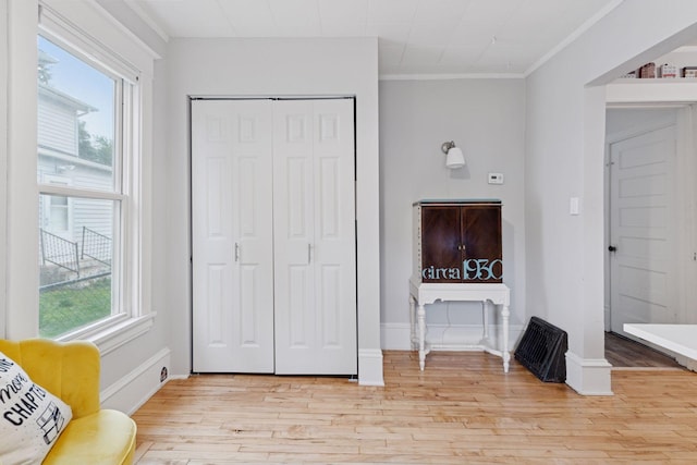 1219 6th St NE, Minneapolis, MN 55413 - living room with healthy amount of natural light, light wood-type flooring, and ornamental molding