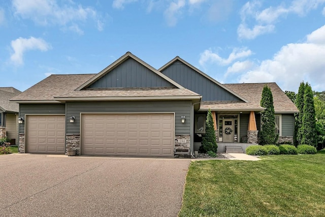 944 Cove Ct NW, Sauk Rapids, MN 56379 - craftsman house with stone siding, an attached garage, a front yard, board and batten siding, and asphalt driveway