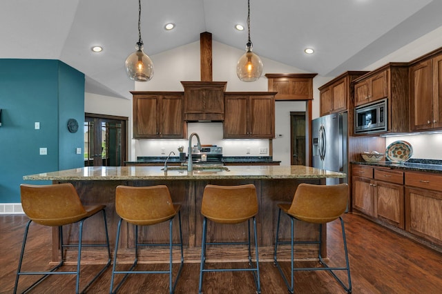 944 Cove Ct NW, Sauk Rapids, MN 56379 - kitchen with stainless steel appliances, a sink, an island with sink, dark stone counters, and a kitchen bar