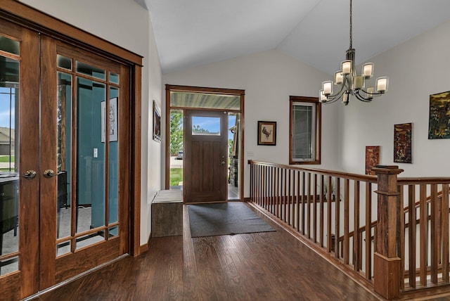 944 Cove Ct NW, Sauk Rapids, MN 56379 - foyer entrance with dark wood-style floors, a chandelier, vaulted ceiling, and french doors