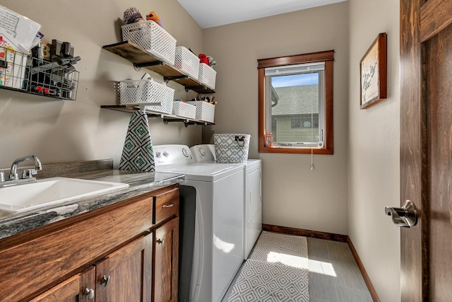 944 Cove Ct NW, Sauk Rapids, MN 56379 - laundry room with washing machine and clothes dryer, baseboards, and cabinet space