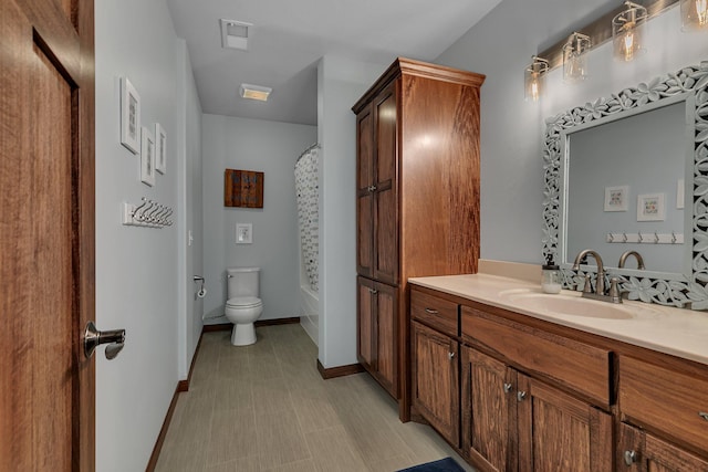 944 Cove Ct NW, Sauk Rapids, MN 56379 - bathroom with vanity, toilet, baseboards, and shower / tub combo