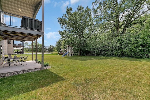 944 Cove Ct NW, Sauk Rapids, MN 56379 - view of green lawn with a playground and a patio