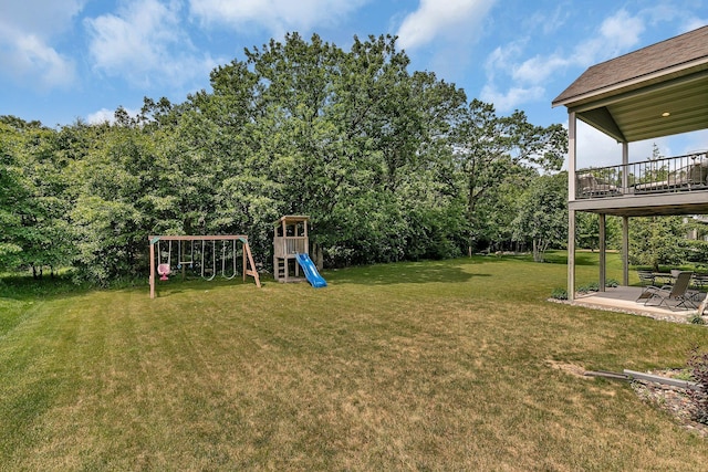 944 Cove Ct NW, Sauk Rapids, MN 56379 - view of grassy yard with a playground and a patio area