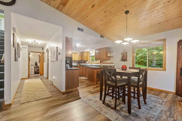 32157 County Road 39, Breezy Point, MN 56472 - dining room featuring vaulted ceiling, stairs, light wood-type flooring, a chandelier, and wood ceiling