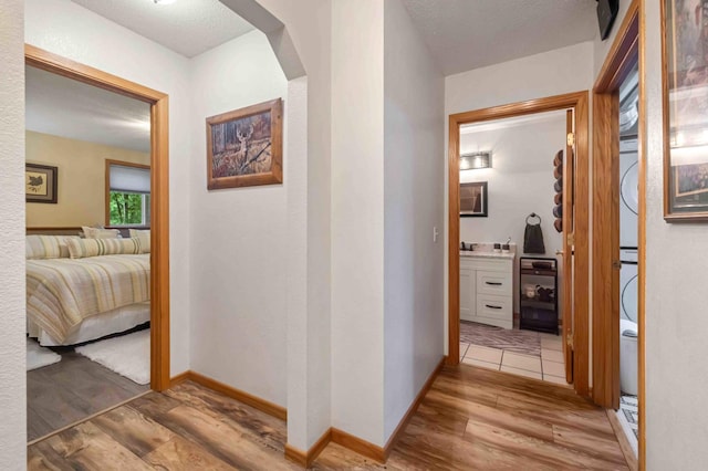 32157 County Road 39, Breezy Point, MN 56472 - corridor featuring light wood-style flooring, stacked washer / dryer, and arched walkways