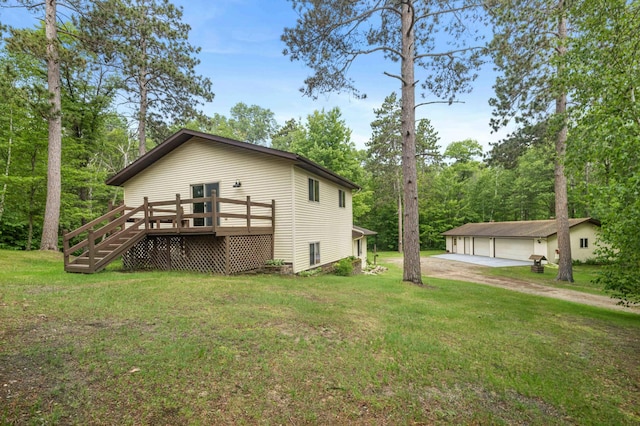 32157 County Road 39, Breezy Point, MN 56472 - view of side of property featuring a detached garage, a yard, a wooden deck, and an outdoor structure