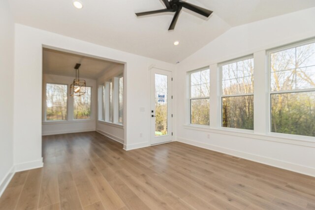 19908 67th Ave, Corcoran, MN 55340 - unfurnished room with a ceiling fan, baseboards, vaulted ceiling, light wood-type flooring, and recessed lighting