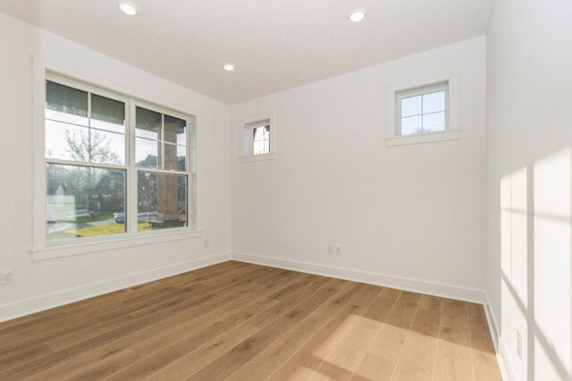 19908 67th Ave, Corcoran, MN 55340 - spare room with light wood-type flooring, baseboards, and recessed lighting