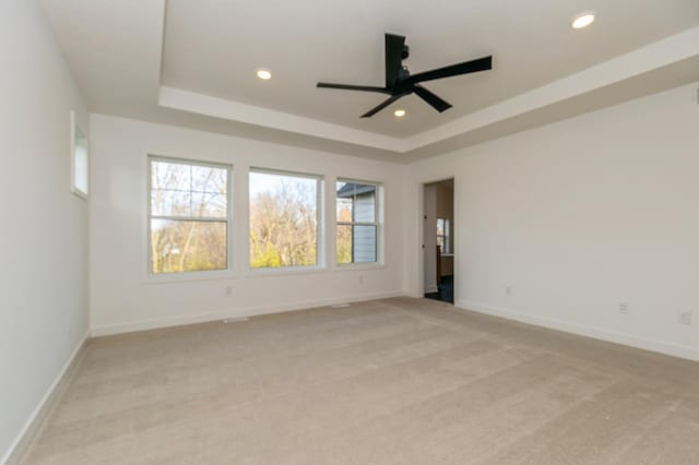 19908 67th Ave, Corcoran, MN 55340 - unfurnished room featuring a raised ceiling, a ceiling fan, light colored carpet, recessed lighting, and baseboards