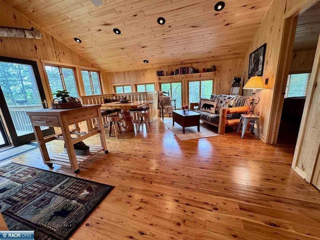 3069 Black Bay Rd, Cook, MN 55723 - living area with lofted ceiling, wooden walls, wood ceiling, and hardwood / wood-style flooring
