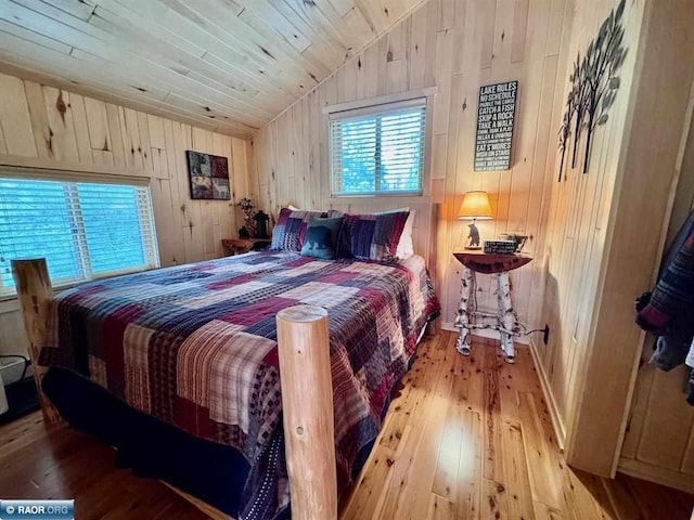 3069 Black Bay Rd, Cook, MN 55723 - bedroom with vaulted ceiling, wood-type flooring, wooden walls, and wooden ceiling