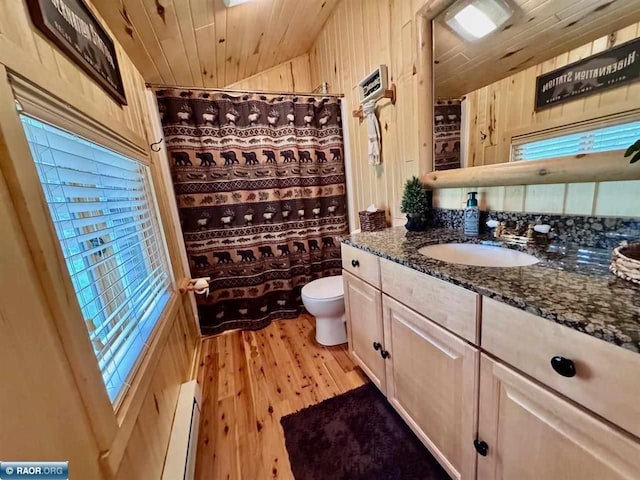 3069 Black Bay Rd, Cook, MN 55723 - bathroom with a baseboard heating unit, toilet, lofted ceiling, wooden walls, and wooden ceiling
