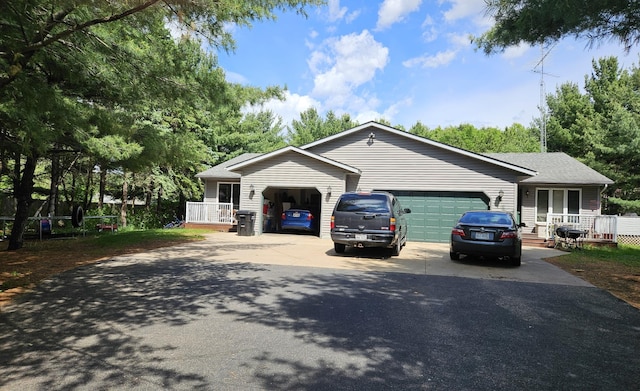 N7018/N7020 564th St, Red Cedar Twp, WI 54751 - ranch-style house with asphalt driveway, an attached garage, a shingled roof, and a porch