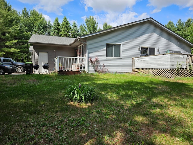 N7018/N7020 564th St, Red Cedar Twp, WI 54751 - back of house with a lawn and a deck
