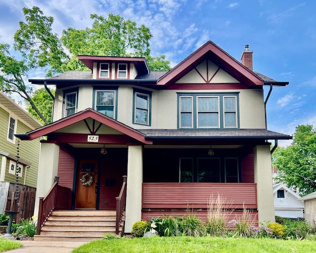 523 6th St SW, Rochester, MN 55902 - view of front of house featuring a porch, stucco siding, a chimney, and a shingled roof