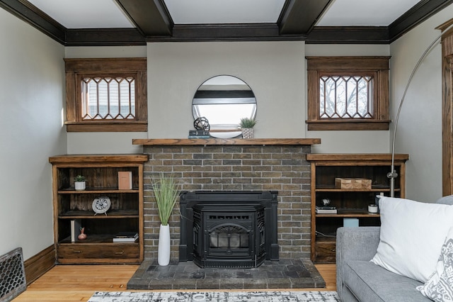 523 6th St SW, Rochester, MN 55902 - living area with wood finished floors, crown molding, healthy amount of natural light, a wood stove, and baseboards