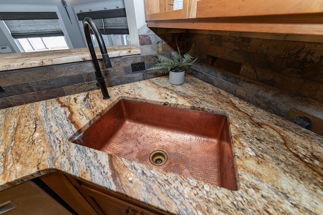 523 6th St SW, Rochester, MN 55902 - detailed view of a sink, light stone countertops, and decorative backsplash
