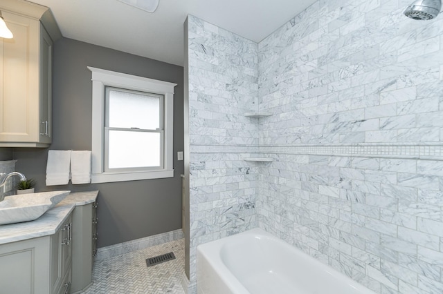 523 6th St SW, Rochester, MN 55902 - full bath featuring vanity, tile patterned flooring, shower / washtub combination, and baseboards