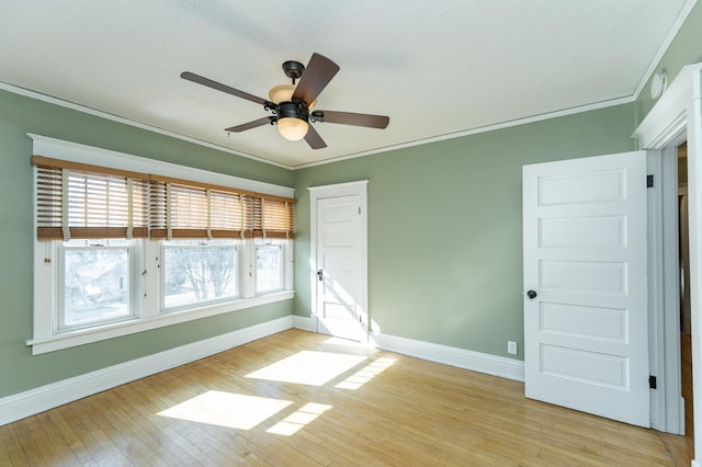 523 6th St SW, Rochester, MN 55902 - empty room featuring baseboards, crown molding, light wood-type flooring, a ceiling fan, and a smoke detector