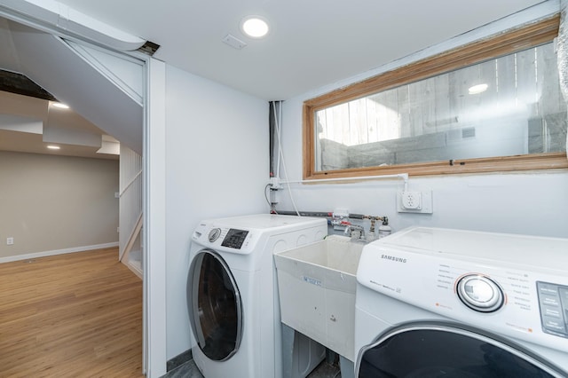 523 6th St SW, Rochester, MN 55902 - washroom with baseboards, light wood-style floors, washer and dryer, and recessed lighting