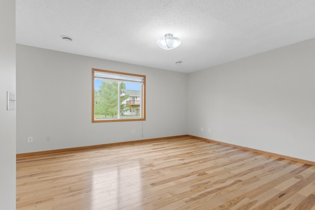 2909 Molina St, Shakopee, MN 55379 - empty room featuring light wood-type flooring and a textured ceiling