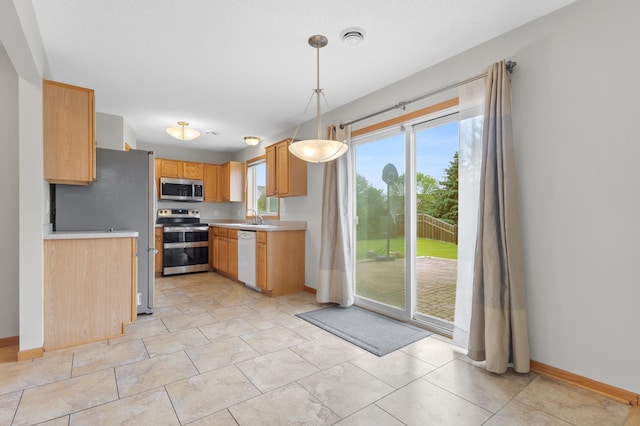 2909 Molina St, Shakopee, MN 55379 - kitchen featuring stainless steel appliances, light countertops, and pendant lighting