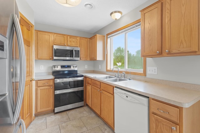 2909 Molina St, Shakopee, MN 55379 - kitchen featuring stainless steel appliances, light countertops, and light tile patterned flooring