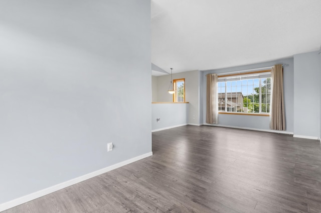 2909 Molina St, Shakopee, MN 55379 - spare room featuring dark wood-style flooring and vaulted ceiling
