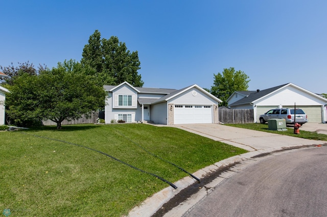715 49th St S, Fargo, ND 58103 - tri-level home featuring an attached garage and concrete driveway
