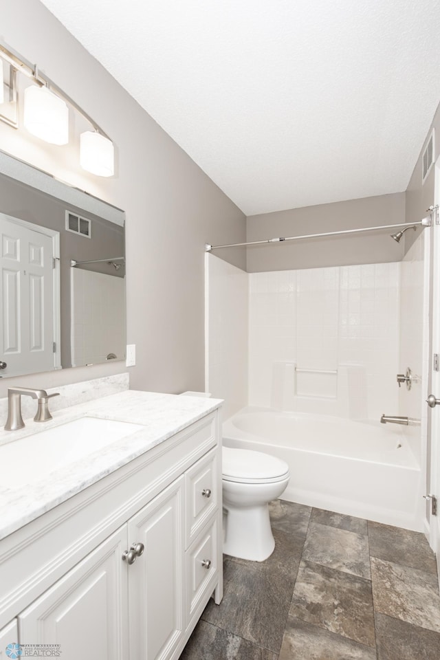 715 49th St S, Fargo, ND 58103 - full bathroom with vanity, toilet, bathtub / shower combination, and stone finish flooring