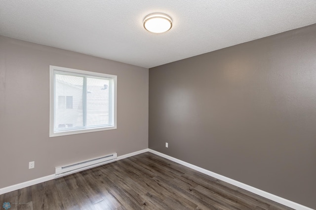 715 49th St S, Fargo, ND 58103 - spare room with a baseboard radiator, dark wood-type flooring, and baseboards