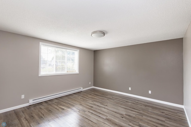 715 49th St S, Fargo, ND 58103 - unfurnished room featuring a baseboard heating unit, wood finished floors, baseboards, and a textured ceiling