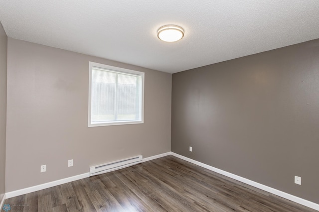 715 49th St S, Fargo, ND 58103 - empty room with baseboard heating, dark wood-style floors, and baseboards