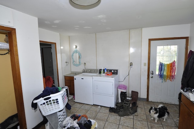 69198 235th St, Dexter, MN 55926 - laundry area featuring washing machine and clothes dryer, light tile patterned flooring, and cabinet space