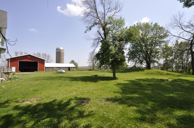 69198 235th St, Dexter, MN 55926 - view of grassy yard featuring a pole building, a detached garage, an outbuilding, and driveway