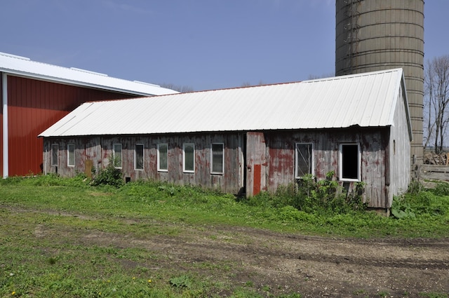 69198 235th St, Dexter, MN 55926 - view of property exterior featuring a metal roof and an outbuilding